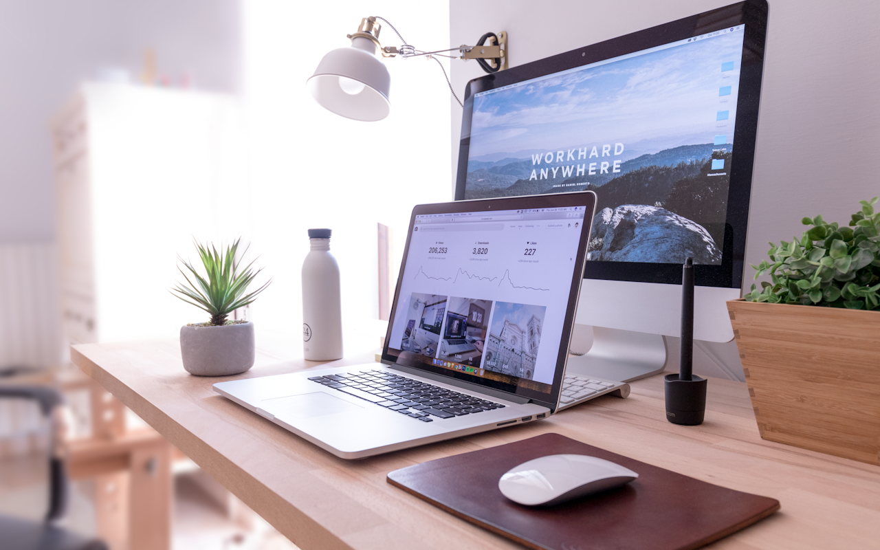 Developer reviewing store code across a multi-screen desk setup